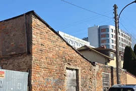 opuszczony dom przy niedokończonym bloku